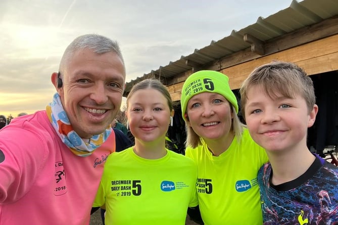 Jackie and Mark Smith, founders of the December Daily Dash, pictured with their children.