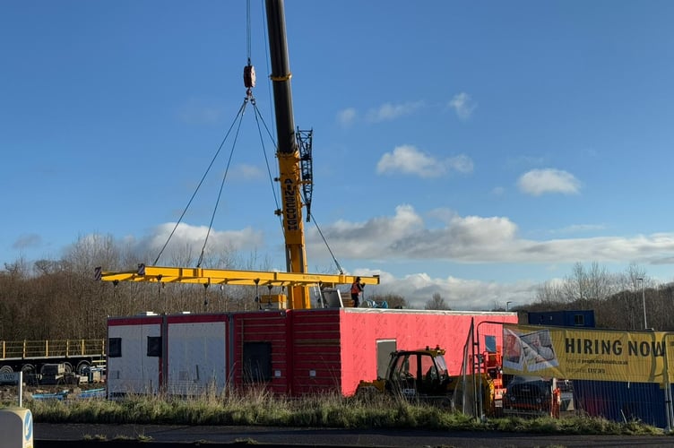 Crane assembling new McDonald's restaurant on site off Joseph Locke Way, Crediton