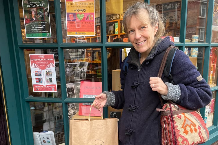 Francisca Van Holthoon with her prize outside the Bookery on Crediton High Street