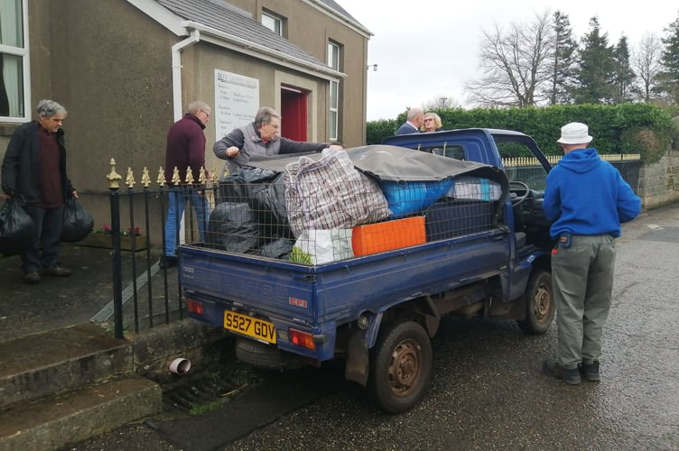 A Daihatsu pickup truck filled with donations