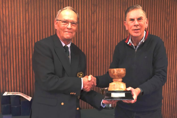 Seniors Captain Peter Blinkhorn, left, presented David Cousins with the Seniors Champion of Champions Trophy.
