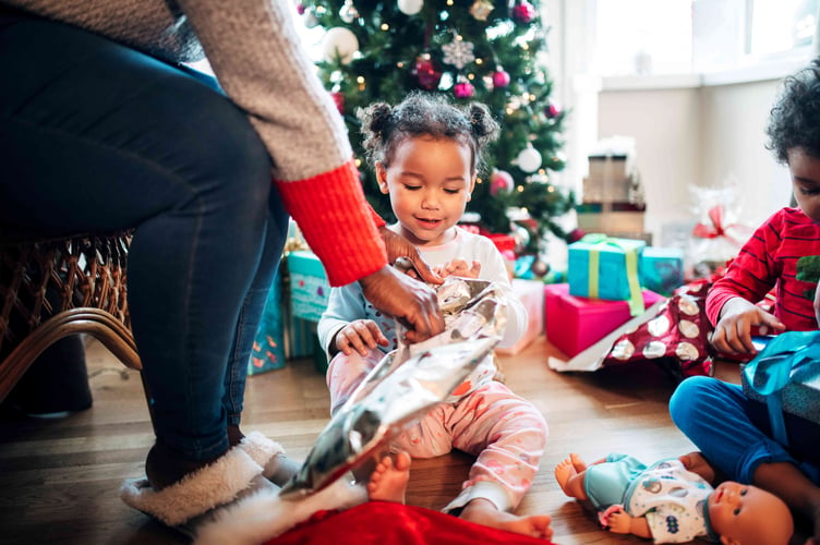 A child receiving a toy donated through the Tesco pre-Christmas toy appeal.
