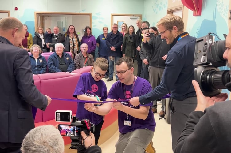 Young patient Tim Harvey officially opens the new Children’s Emergency Department area, pictured with RDHC Fundraiser Tom Derby-Clark and right, Gavin Best, Clinical Project Manager, at the Royal Devon and Exeter Hospital. 
